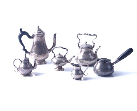 SIX ITEMS OF MINIATURE TEA WARES (6)Comprising; a coffee pot of baluster form, having a black handle, two kettles, a teapot, 