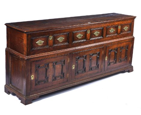 AN 17TH CENTURY AND LATER OAK DRESSER BASEWith three drawers over three geometric moulded cupboards on bracket feet, 202cm wi