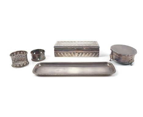 FIVE ITEMS OF SILVER (5)Comprising; a rectangular hinge lidded box, having partly fluted decoration, length 15.5 cm, a napkin