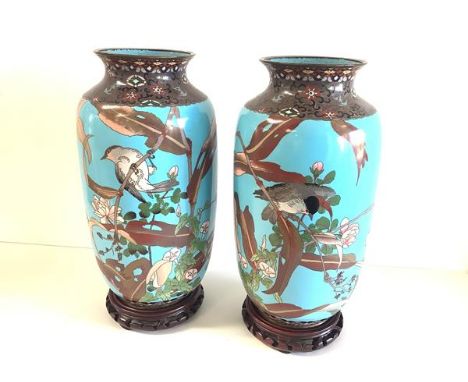 A pair of Japanese cloisonne enamel vases, each of baluster form with everted rim, decorated with birds perched on blossoming