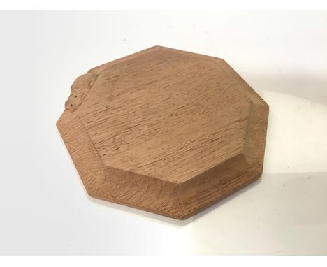 Workshop of Robert "Mouseman" Thompson, a small oak stand or board, octagonal, with carved mouse signature. Diameter 19.5cm