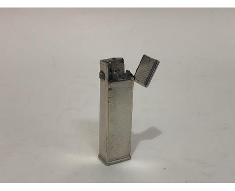 A vintage Dunhill white metal pocket lighter, with Cartier Licence, and engine-turned body. 6.5cm