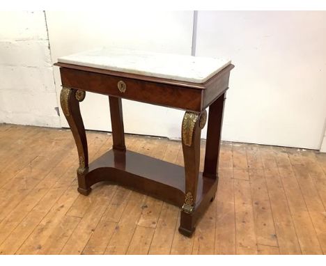 An early 19th century French mahogany and gilt-metal mounted console table, the rectangular Carrara marble top above a frieze
