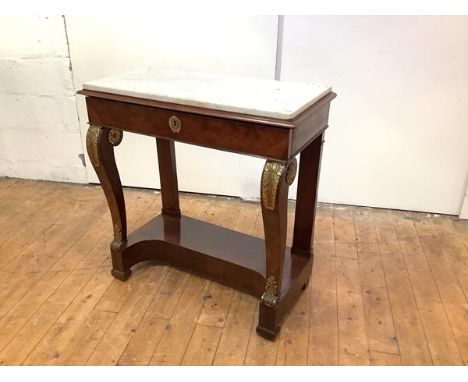 An early 19th century French mahogany and gilt-metal mounted console table, the rectangular Carrara marble top above a frieze