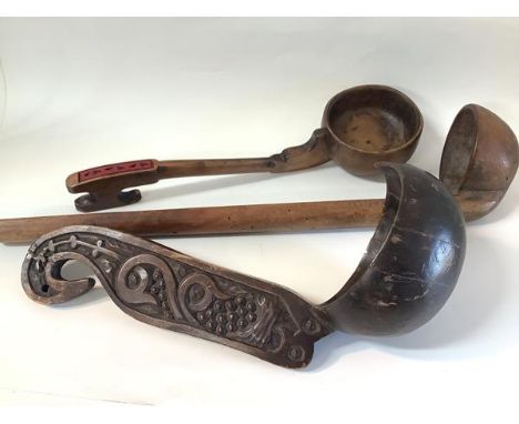 A coconut shell and carved wooden ladle, possibly Papua, New Guinea, the handle carved in relief with scrolls; together with 