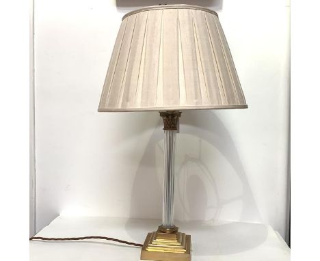 A modern brass and glass Corinthian columnar table lamp, with fluted glass column, on a square stepped base, with pleated sil