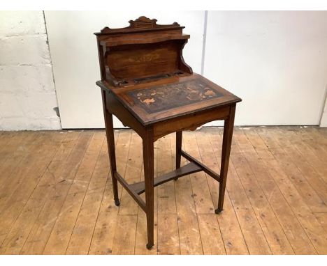 An Edwardian rosewood and boxwood-lined writing desk of small proportions, the raised gallery with shaped shelf above a pen a