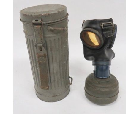 German Third Reich Gas Mask black rubber covered facepiece with blue painted, circular eye lens frames and lower body. Harnes