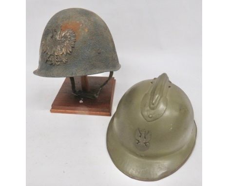 Two WW2 Polish Steel Helmets consisting French M1926, green painted, steel helmet with top comb. The front fitted with crude,