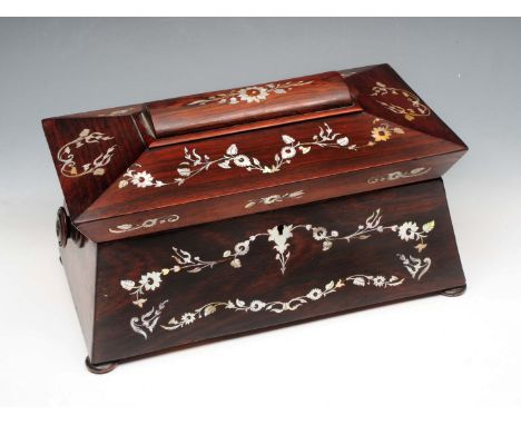 A MID VICTORIAN ROSEWOOD AND MOTHER OF PEARL INLAID TEA CADDY of sarcophagus form, having fitted interior with removable lidd