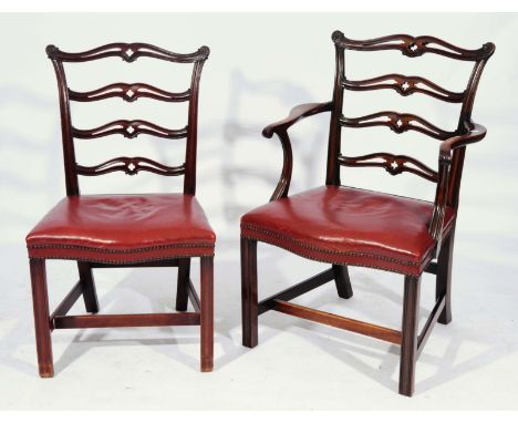 A SET OF EIGHT CHIPPENDALE STYLE MAHOGANY DINING CHAIRS consisting of two carvers and six standards each with wavy splat back