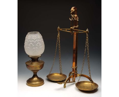 A SET BRASS BALANCE SCALES by W & T Avery, Birmingham, 69cm high and a brass oil lamp with embossed opaque glass shade (2)