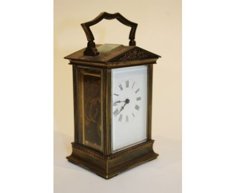A FRENCH BRASS CARRIAGE TIMEPIECE with architectural case, white enamel dial and Roman numerals, 12cm high