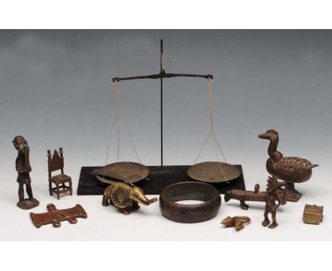 A COLLECTION OF ASHANTI GOLD WEIGHTS of varying stylised designs and set of gold scales; together with a similar iron ring or