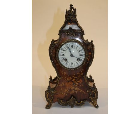 A FRENCH ROSEWOOD AND MARQUETRY INLAID ROCOCO MANTEL CLOCK, the striking mechanism with white enamel dial and Roman numerals,