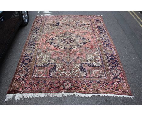 A HEREZ BRICK RED GROUND SMALL CARPET with a central diamond medallion within a multiple border, 320 x 237cm (old repairs)