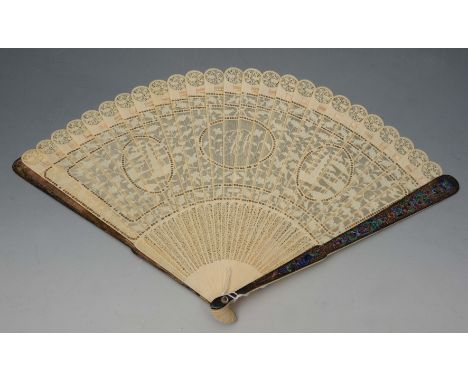 A CHINESE EXPORT PIERCED IVORY FAN with central monogram and polychrome enamel struts (some repair required), 39cm across ope