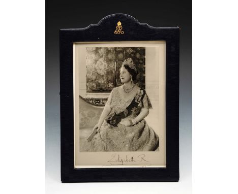 A PHOTOGRAPHIC PORTRAIT of HRH Elizabeth, The Queen Mother, apparently signed by her and dated 1967 in a monogrammed blue lea