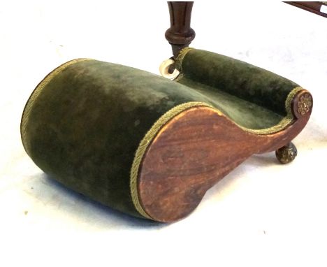 A Victorian gout stool
The scrolled form of simulated rosewood construction applied with decorative gilt metal mounts, uphols