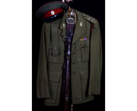 A British Royal Army Ordnance Corps Captains uniform, mid 20th Century
With jacket with medal ribbons for WWII, Sam Brown, tr