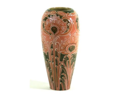 A William Moorcroft Florian ware vase of cylindrical form
Decorated in the peacock feathers pattern on a salmon and light gre