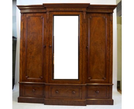 A fine quality Victorian feathered mahogany veneered breakfront wardrobe
The moulded cornice above central mirrored door encl