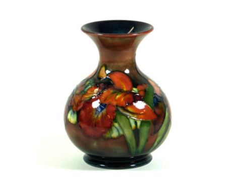 Walter Moorcroft pottery Flambé vase of bulbous form with flared neck
Decorated in the Orchid pattern on a flambé ground, imp