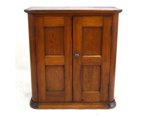 A late Victorian/Edwardian pitch pine side cupboard
The rectangular top with front rounded corners above two panelled doors e