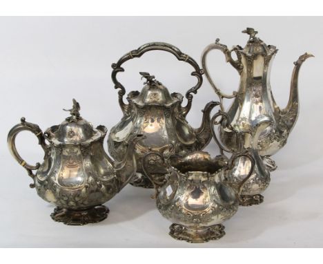 A Victorian silver plated five piece tea and coffee service
Of panelled baluster form, the domed lids with cast finials model