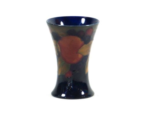 Walter Moorcroft pottery beaker of wasted cylindrical form
Decorated in the pomegranate pattern on a grey and blue ground, im