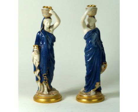 Royal Worcester pair of figures
Modelled in the form of Grecian water collectors supports vases on their heads, each wearing 