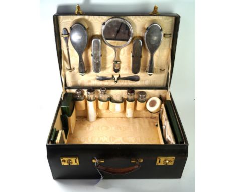A ladies leather travelling case early 20th Century
The interior fitted out with silver backed hairbrushes, two clothes brush