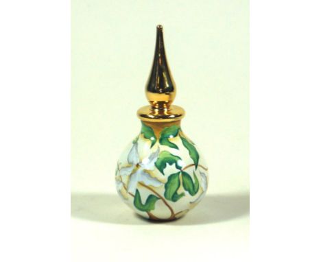 A Modern Moorcroft enamel perfume bottle and stopper
Decorated with Magnolia on an ivory ground, printed factory marks to bas