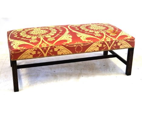 A large Chippendale-style window seat/stool, 20th Century
The upholstered rectangular top raised on four blind fret carved sq