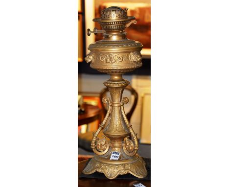A gilded metal oil lamp marked for Hinks & Son Patent, circa late 19th/early 20th century, decorated with lion mask finails, 