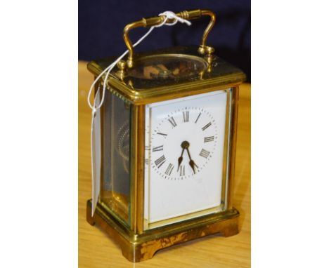 A French brass carriage clock, with single train movement, white enamel dial, and carry handle, 16cm high