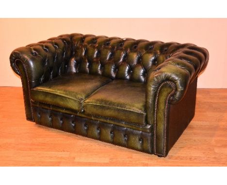 A good quality green leather chesterfield club style two seater sofa, 68cm high x 153cm wide