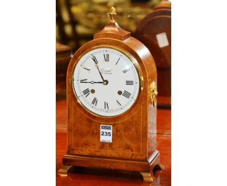 A Regency style mantel clock by Comitti of London, of domed form, with lion mask ring handles, 31cm high
