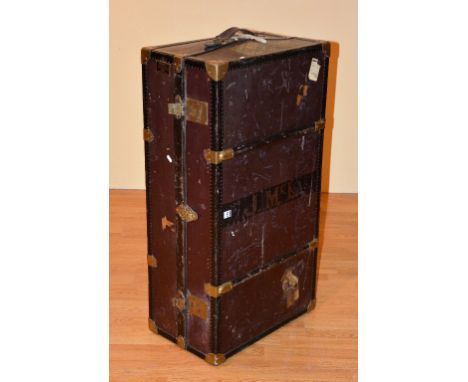 A Vintage gentleman's travel wardrobe/trunk, with label for Finnigans, enclosing fitted coat racks, and compartments, with ca