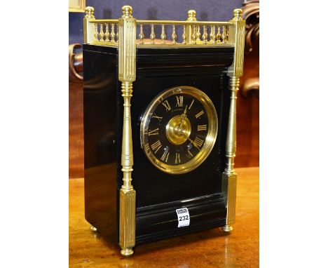A late Victorian black slate mantel clock by Mathieson & co, decorated with brass balustrade gallery and mounts, black enamel