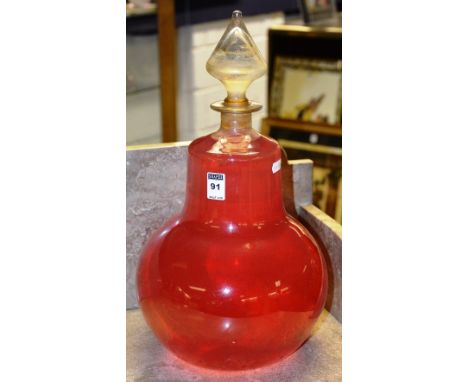 A large vintage glass chemist jar with stopper, jar full with rose water, 44cm high