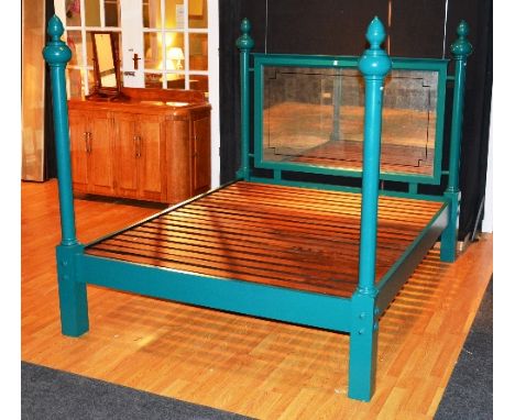 A contemporary green painted bed, with slats, side rails, and mirrored back panel, 216cm long x 170cm wide
