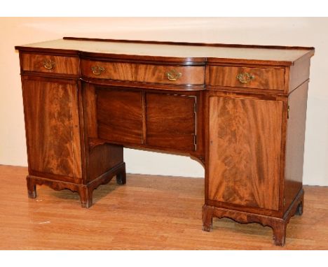 A mahogany sideboard, circa late 19th century/early 20th century, with fitted drawers above panelled doors, raised on bracket