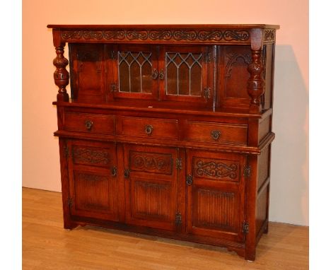 An Old Charm oak court cupboard/dresser, the top section with two leaded glazed doors, with interior light, flanked by a tur