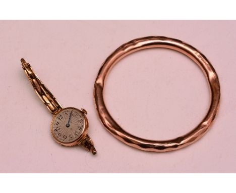 A large 9ct gold bangle, stamped 375, 15.6g, together with a 9ct gold wristwatch, stamped 375 (2)