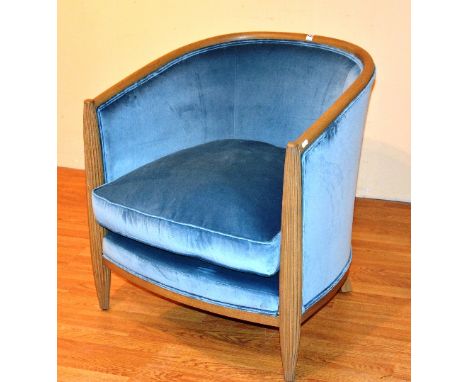 A contemporary light oak framed tub armchair, upholstered in pale blue velour, 78cm high x 74cm wide