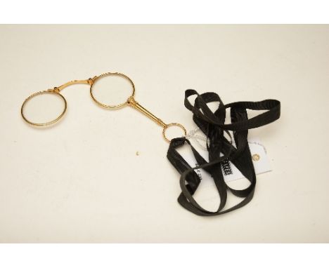 A vintage gold plated lorgnette, with black ribbon attachment, 11cm high