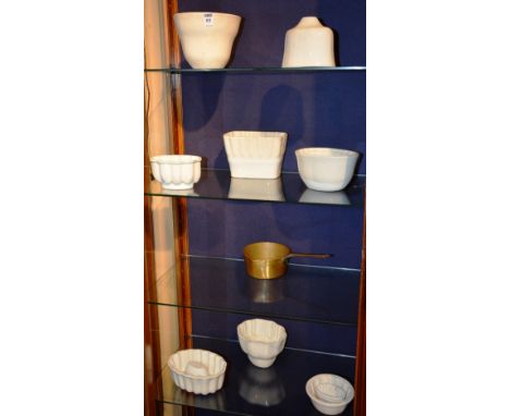 A quantity of vintage pottery jelly moulds, also with brass pot
