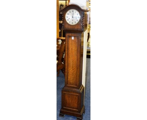 An oak granddaughter clock, with silvered dial above panelled trunk, 48cm high