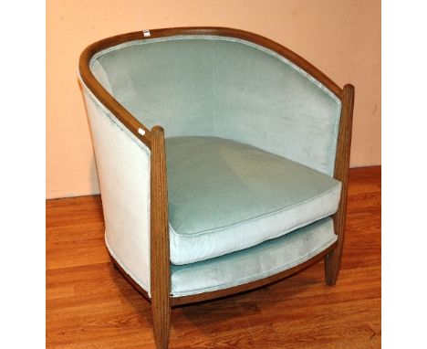 A contemporary light oak framed tub armchair, upholstered in pale green velour, 78cm high x 74cm wide